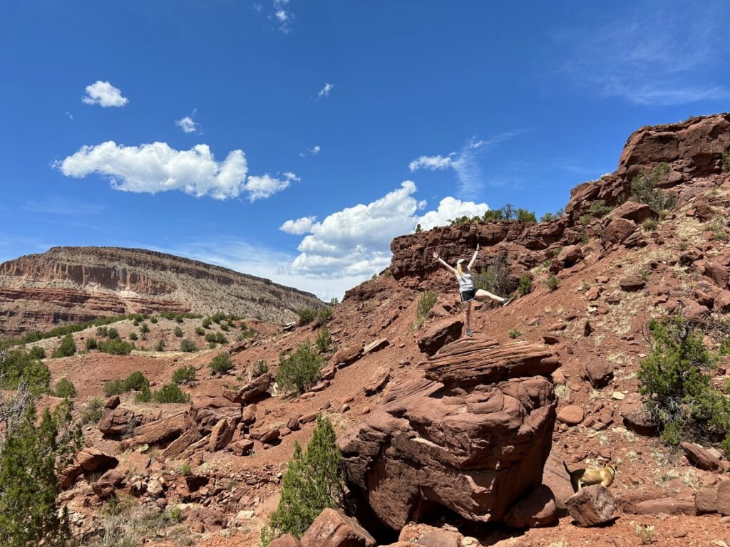 Solo Camping As A Woman: My Safety Tips & Advice When Camping Alone! 6 A person is standing on a rocky cliff.